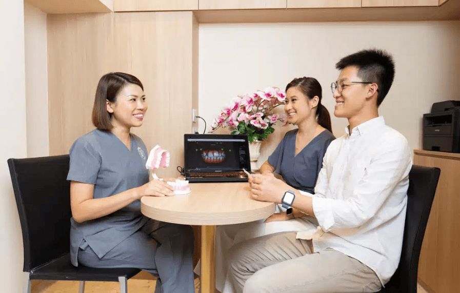Dentist reviewing a CBCT scan and dental implant model to assess bone structure for implant treatment - Newlife Dental Practice